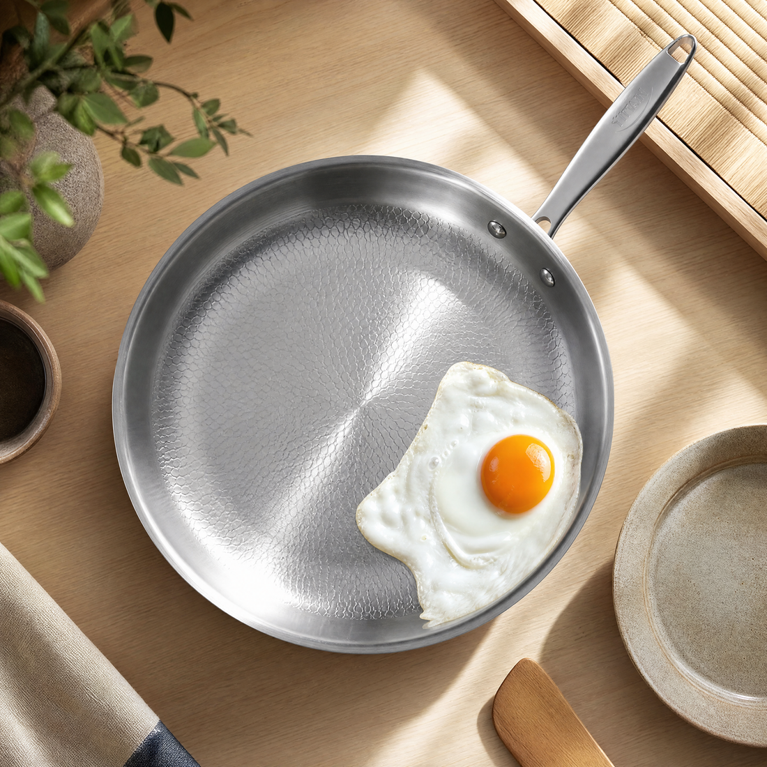Fried eggs sliding off a titanium frying pan
